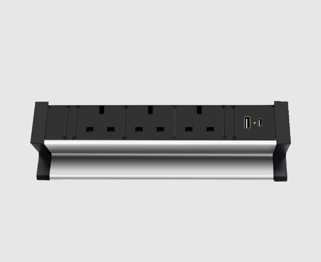DeskEdge PDU mounted on desk edge with multiple power sockets and USB ports for easy access and cable management.